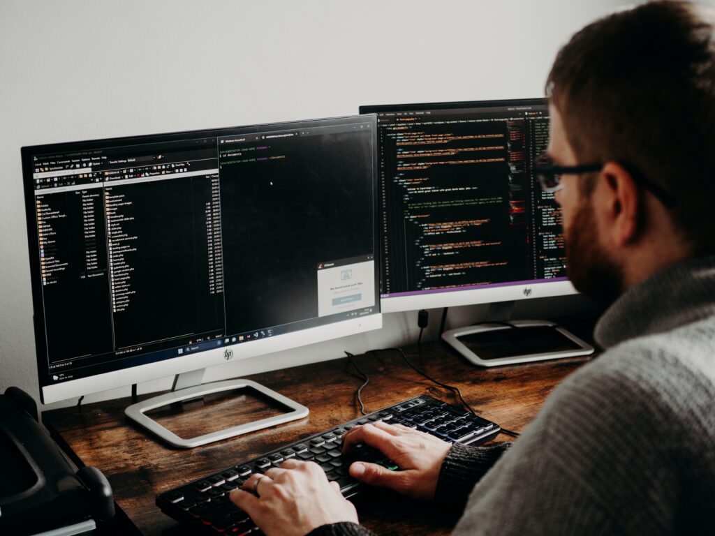 man working on coding custom software development