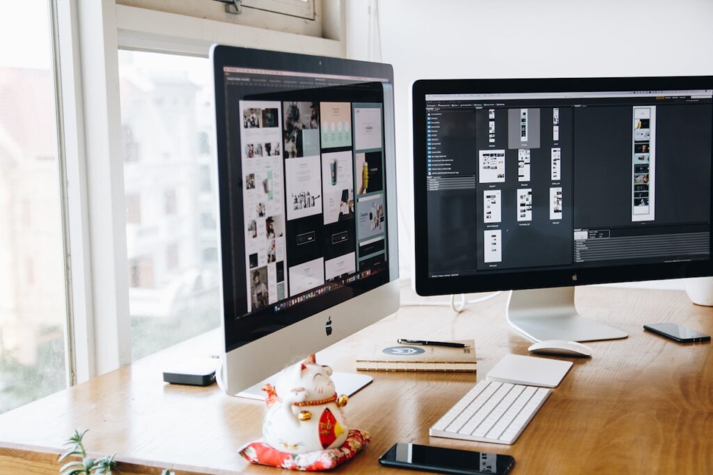 Two imacs on the table for programming